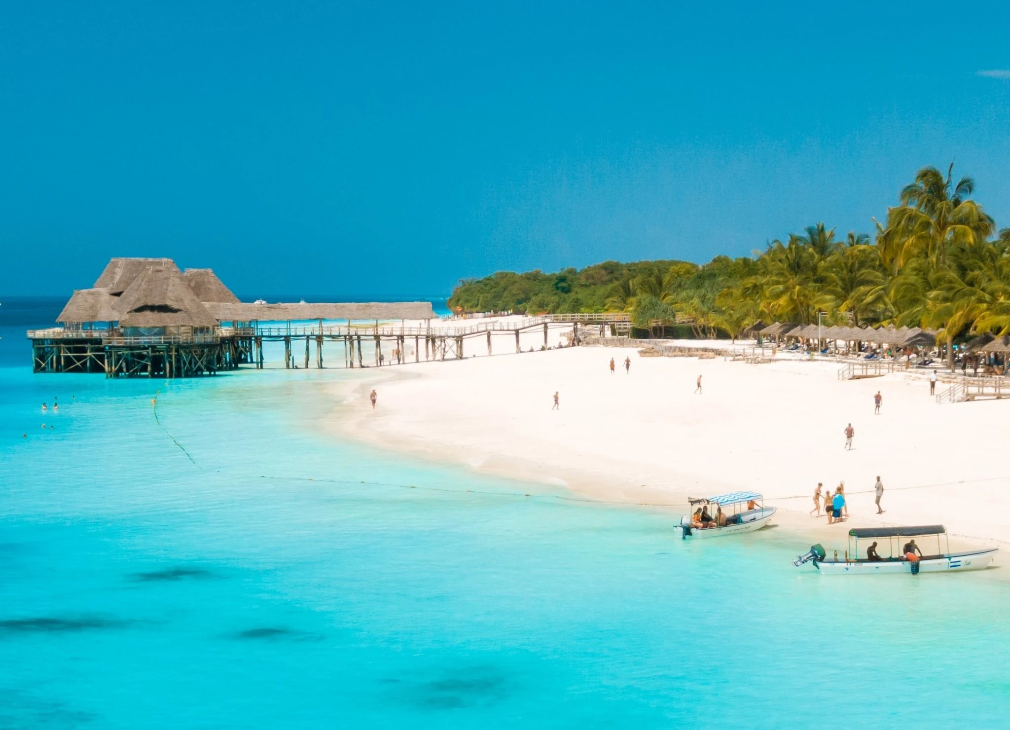 Guests relaxing on the beach at Sudi Island after lunch