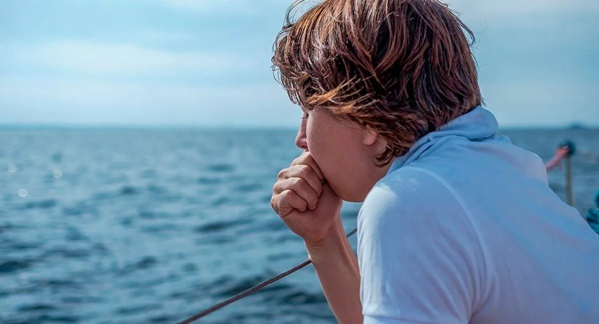 Passenger experiencing seasickness during a boat excursion on the ocean