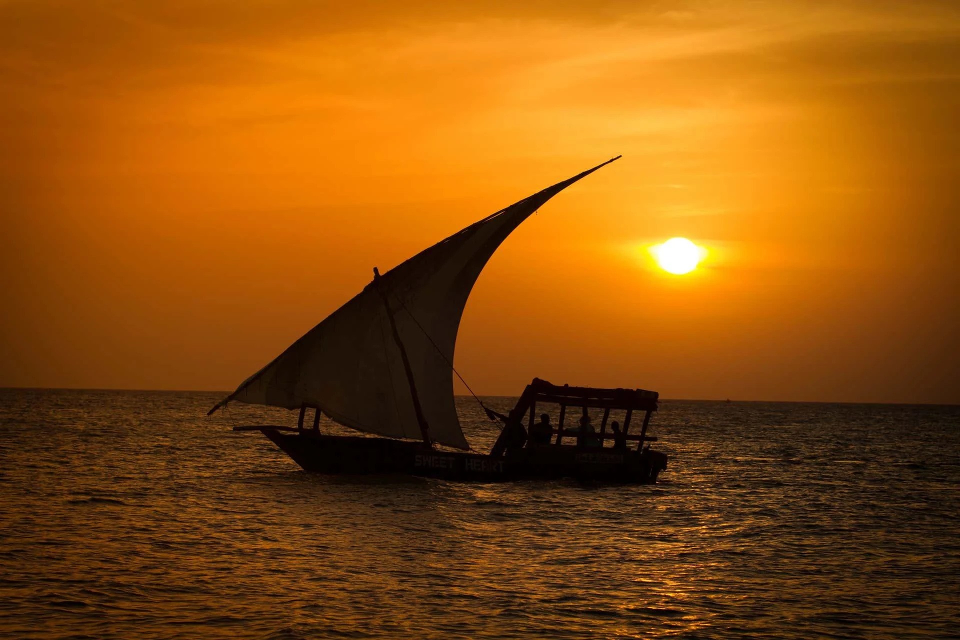 Traditional dhow sailing through Mida Creek at sunset in Watamu Kenya